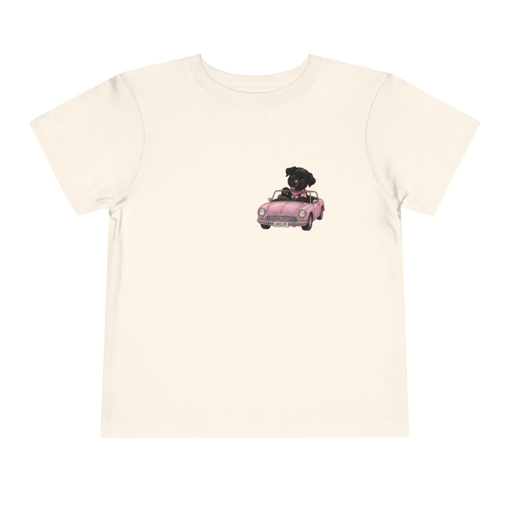 Toddler Tee — Cute Black Dog in Pink Car with "Dream. Believe. Love." Back Print